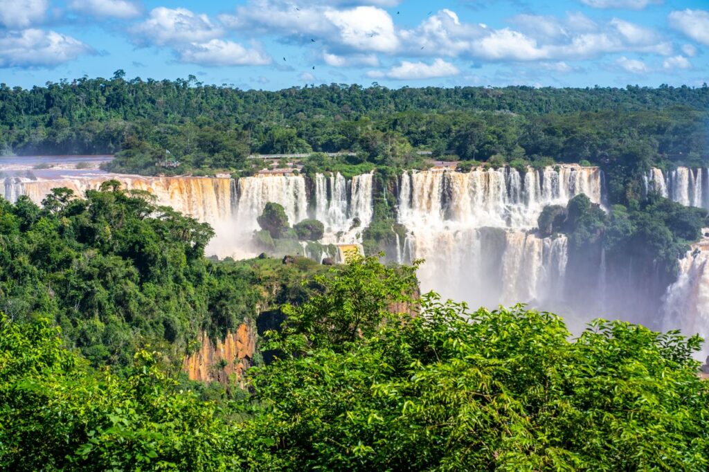 Stunning view of Iguazu Falls cascading through lush greenery, a must-see natural wonder in Argentina.