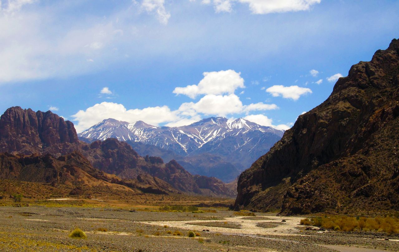 Breathtaking landscape of the Andes mountains in Mendoza, Argentina, under a vibrant blue sky.
