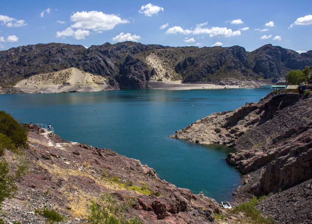 Breathtaking view of Los Reyunos Dam with turquoise waters and rugged mountains in San Rafael, Argentina.