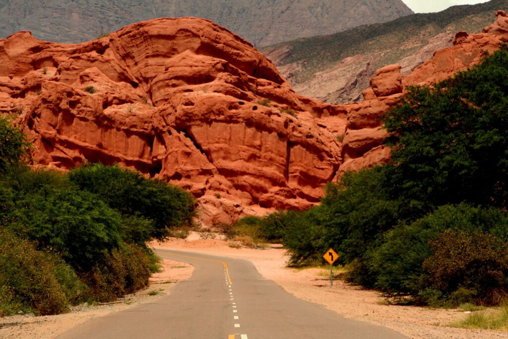 Winding road through Quebrada de las Conchas Canyon with stunning red rock formations.