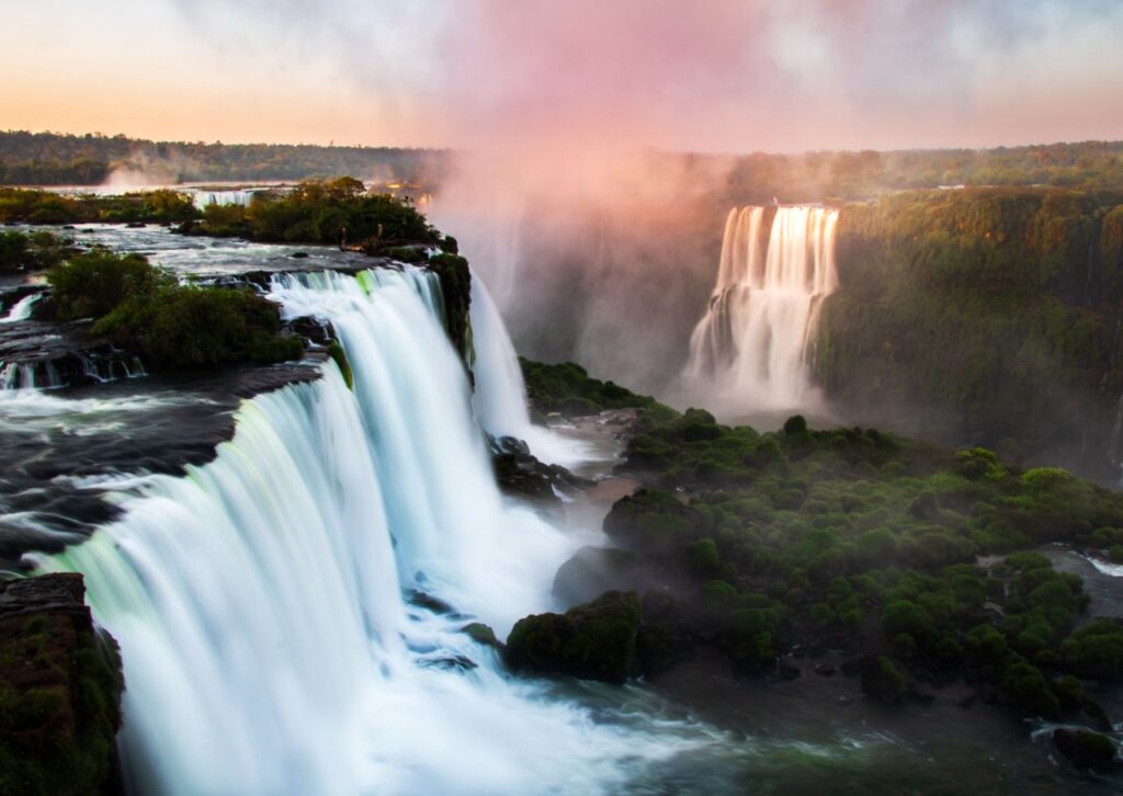 Stunning view of Iguazu Falls with cascading water and morning mist.